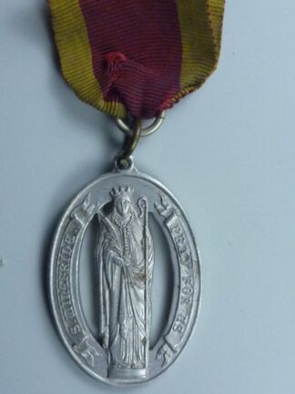 Oval badge with bishop standing